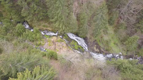 looking down on rausor waterfall, romania from drone overhead