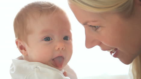 Woman-holding-a-baby-and-kisses-him