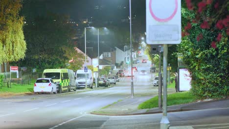 a nighttime scene showing glowing streetlights and cars passing along queensway, a hilly road in hemel hempstead