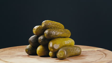 pyramid of pickled cucumbers on a wooden board