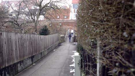 people walking on a city bridge in winter