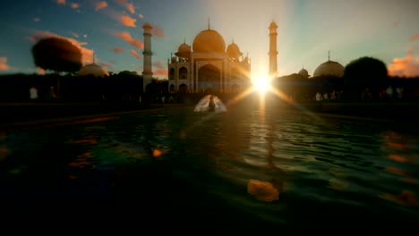 taj mahal with tourists walking against beautiful sunset, zoom in 4k