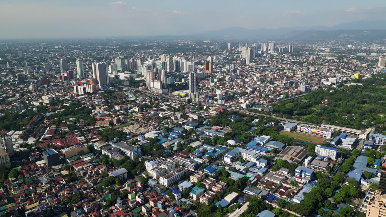 Flyover drone shot of buildings and cityscape of Cubao, Quezon City, Philippines during daytime
