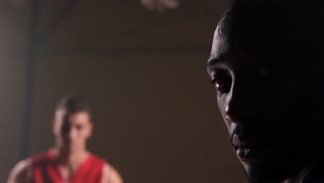 Close-up-of-sportsman-holding-basketball