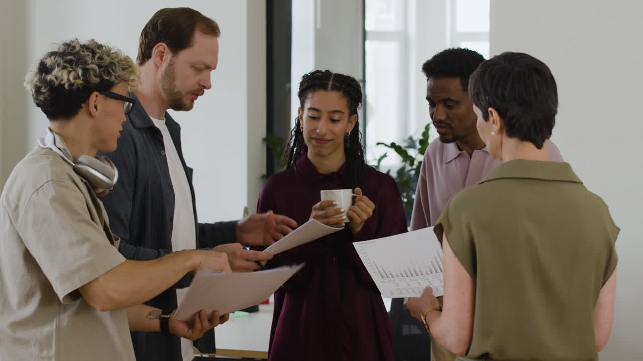 Diverse group of colleagues discussing business documents in an office