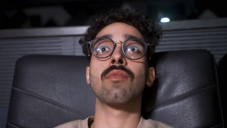 young man sitting in a vip cinema.