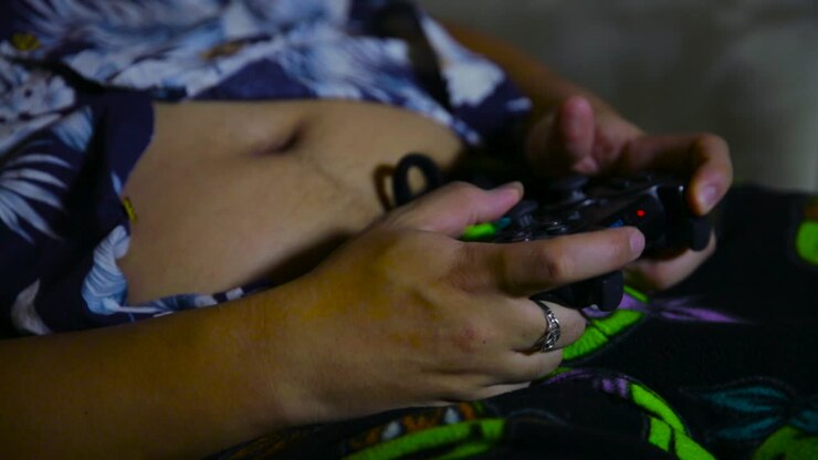Man's hands holding a video game controller