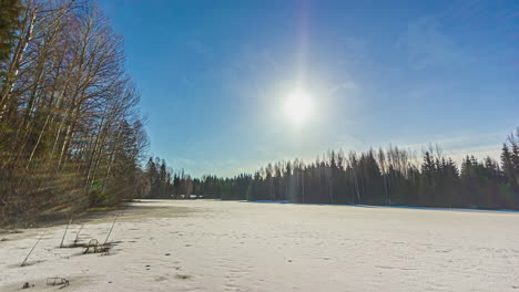 24-hours-time-lapse-of-a-frozen-lake-with-trees-in-winter