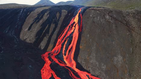 lava river during volcanic eruption at mount fagradalsfjall, southwest iceland - aerial shot