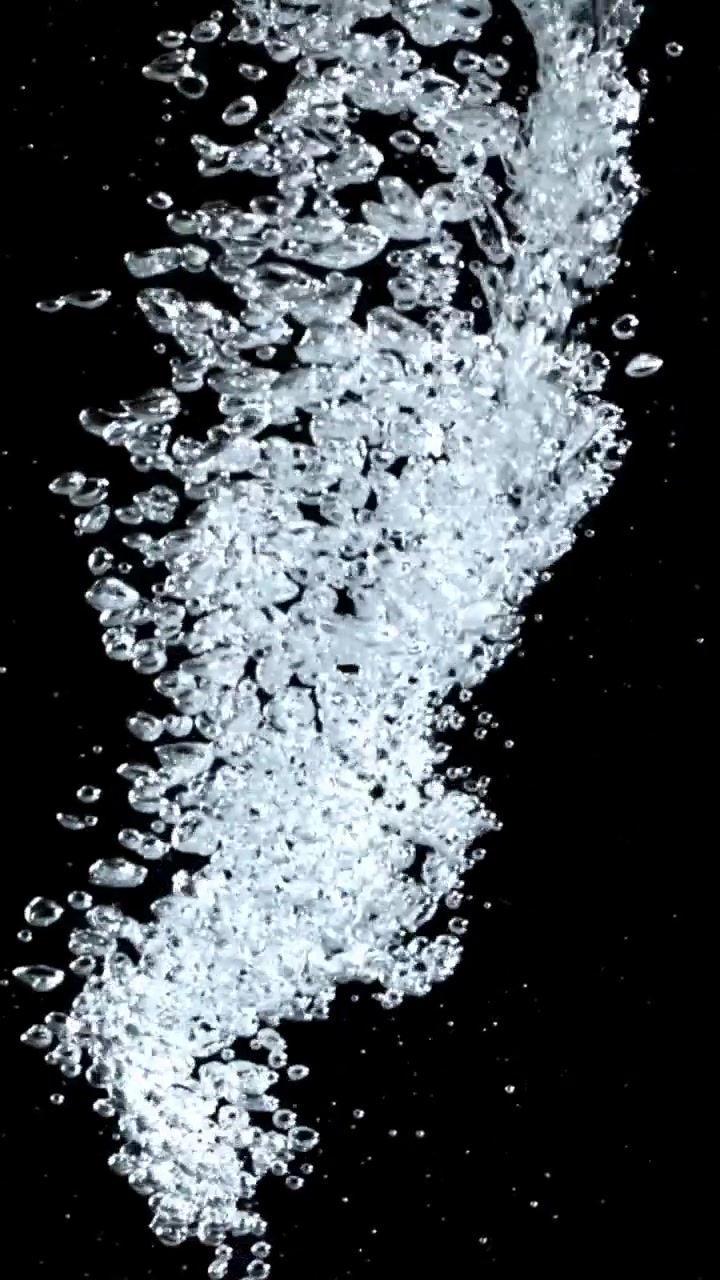 Clear Water Bubbles Rising Against a Black Background
