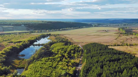 aerial view of a river valley with fields and forests