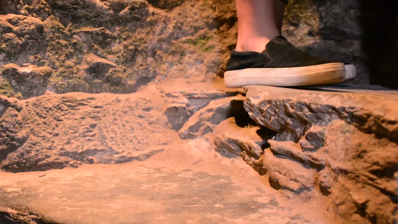 los pies de la gente suben lentamente las escaleras de piedra de cerca