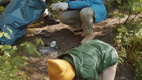 multiracial family cleaning campground together