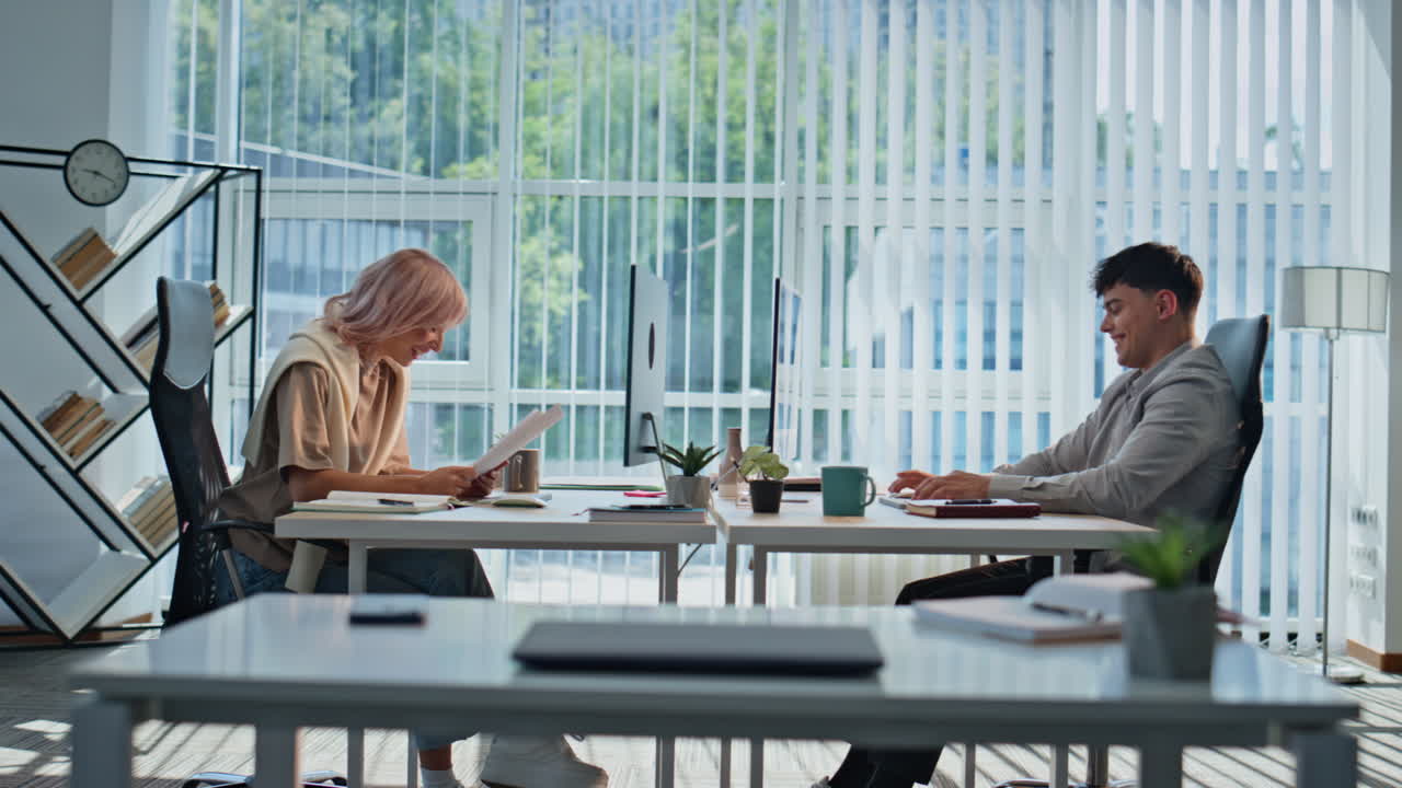 Smiling colleagues informal communication in coworking space. Managers talking