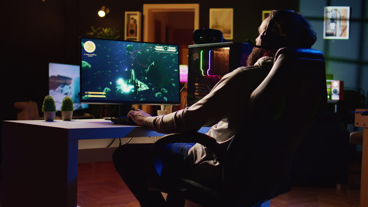 Man in dimly lit apartment playing singleplayer videogame with spaceship shooting