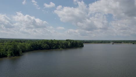 Frontal-tracking-on-big-lake-in-sunny-day-with-magnificent-clouds