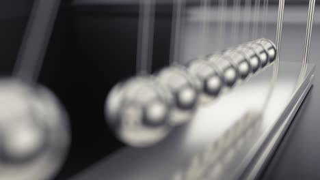 Newton's cradle closeup shot. Shallow depth of field. UHD seamless video. Live focus