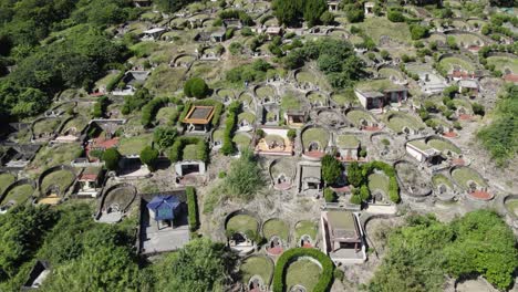 chinese cemetery on mountain side in taiwan, aerial drone shot