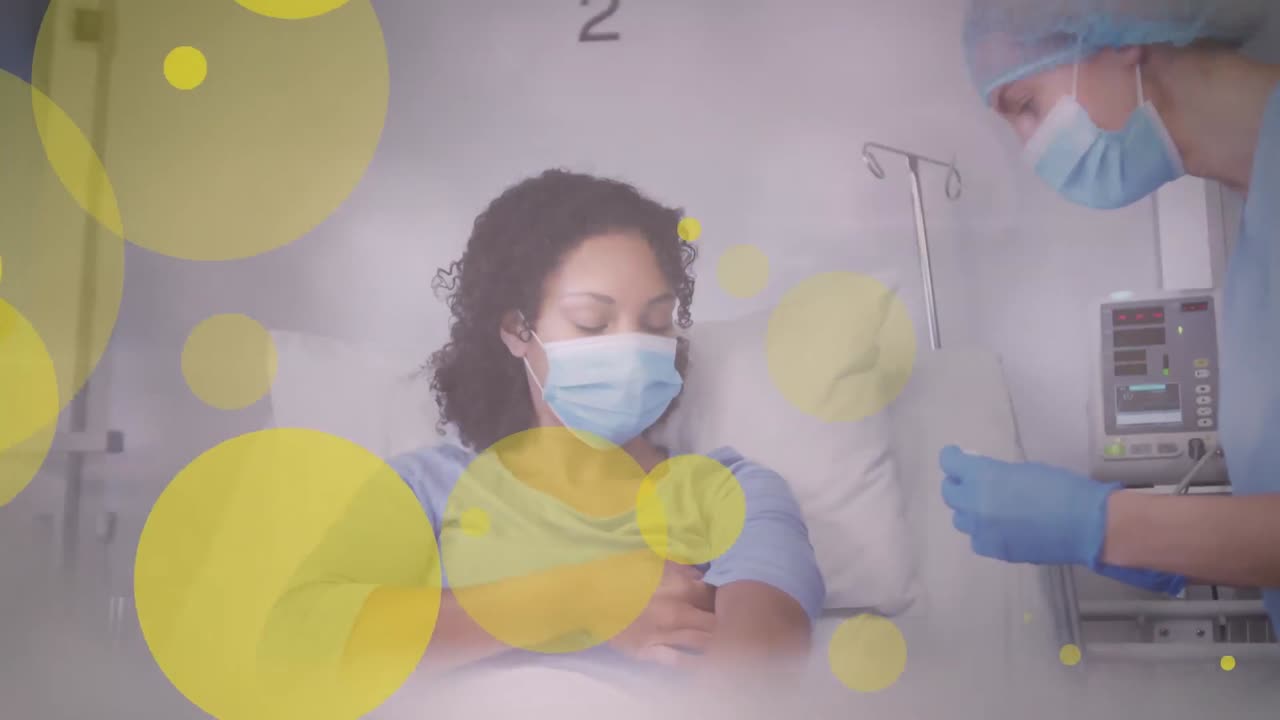 Animation Of Yellow Spots Over Caucasian Female Doctor Giving An ...