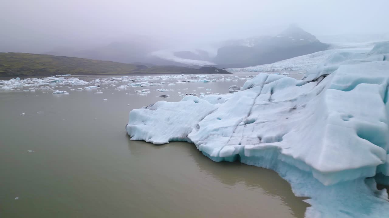 드론이 큰 빙산 주위를 날아다니며 조류 빙하를 드러 ⁇ 니다.