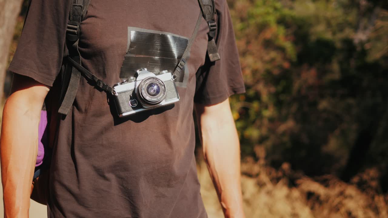 Man hiking with vintage camera