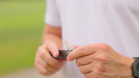 Close-up-of-male-hands-spinning-keys-clipped-in-to-a-modern-minimalist-key-chain