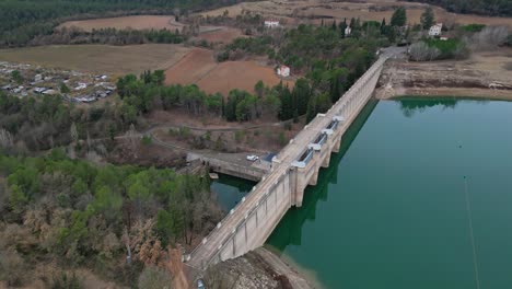 San-ponce-reservoir-in-barcelona-surrounded-by-fields-and-forests,-aerial-view