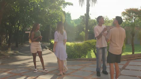 group of young adults socializing and laughing outdoors