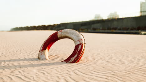 old lifebuoy on sandy beach