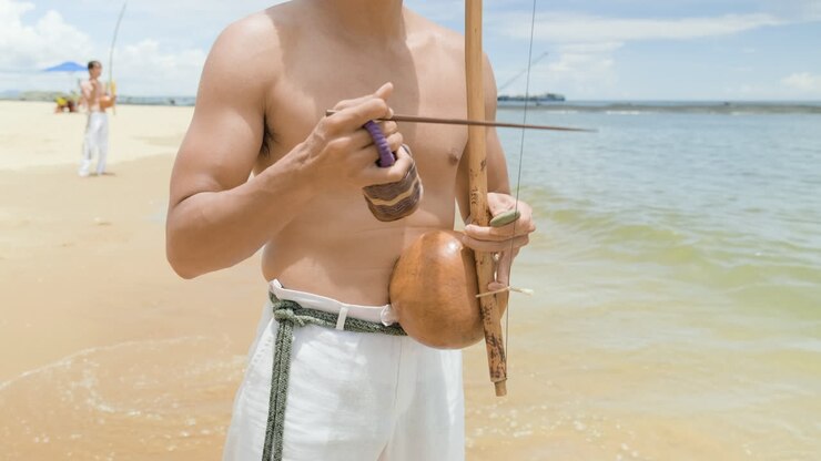 Shirtless man playing instrument