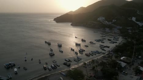 Aerial-View-of-Tatanga,-Beach-and-Bay-Near-Santa-Marta,-Colombia-at-Sunset,-Boats-and-Caribbean-Sea-Horizon