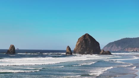 basalt formation of haystack rock rising on the shores of cannon beach, oregon, united states