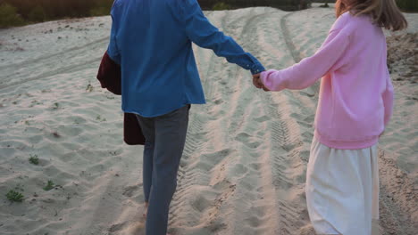 Romantic-couple-holding-hands-by-the-sand