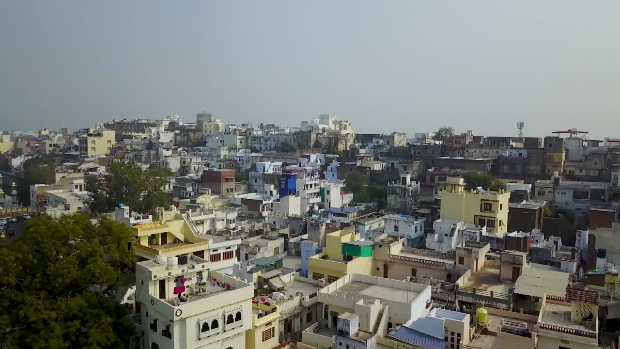 Residential Rooftops Under The Sunlight In Udaipur City, India - aerial drone