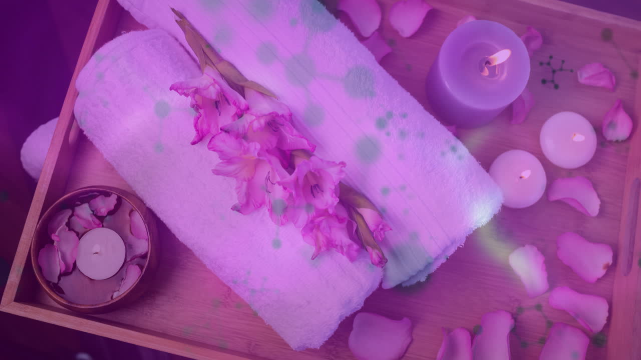 Spa tray arrangement displaying in flat design, showing rolled towels, glowing candles, rose petals