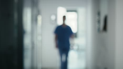 blurred video of medical staff walking across the hospital corridor