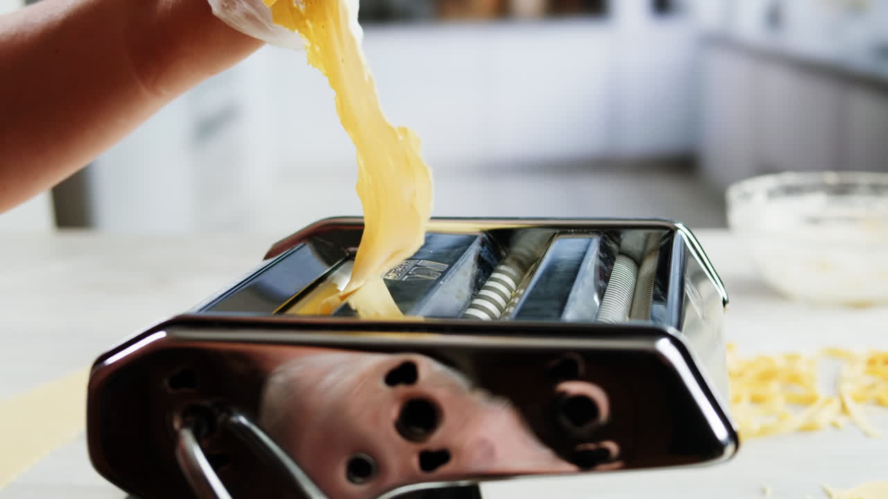 Chef's Hands Preparing Fresh Tagliatelle Pasta in Kitchen