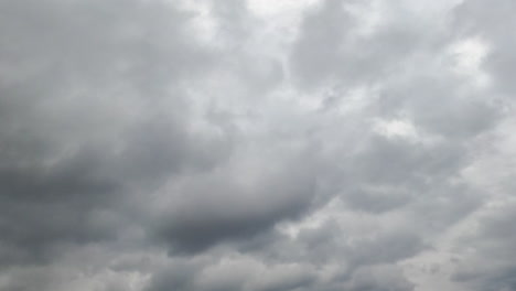 grey gloomy sky at daytime on bad weather. rainy clouds covering the skies. low angle view. timelapse.
