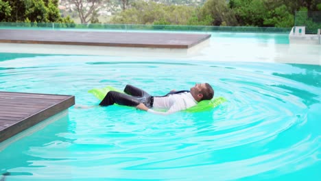 businessman lying on lilo