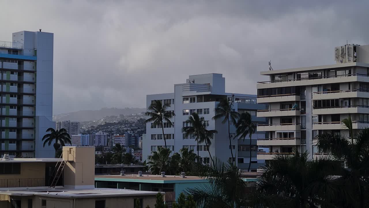 Rainy Clouds Above Apartment Buildings and Hills of Honolulu, Hawaii USA