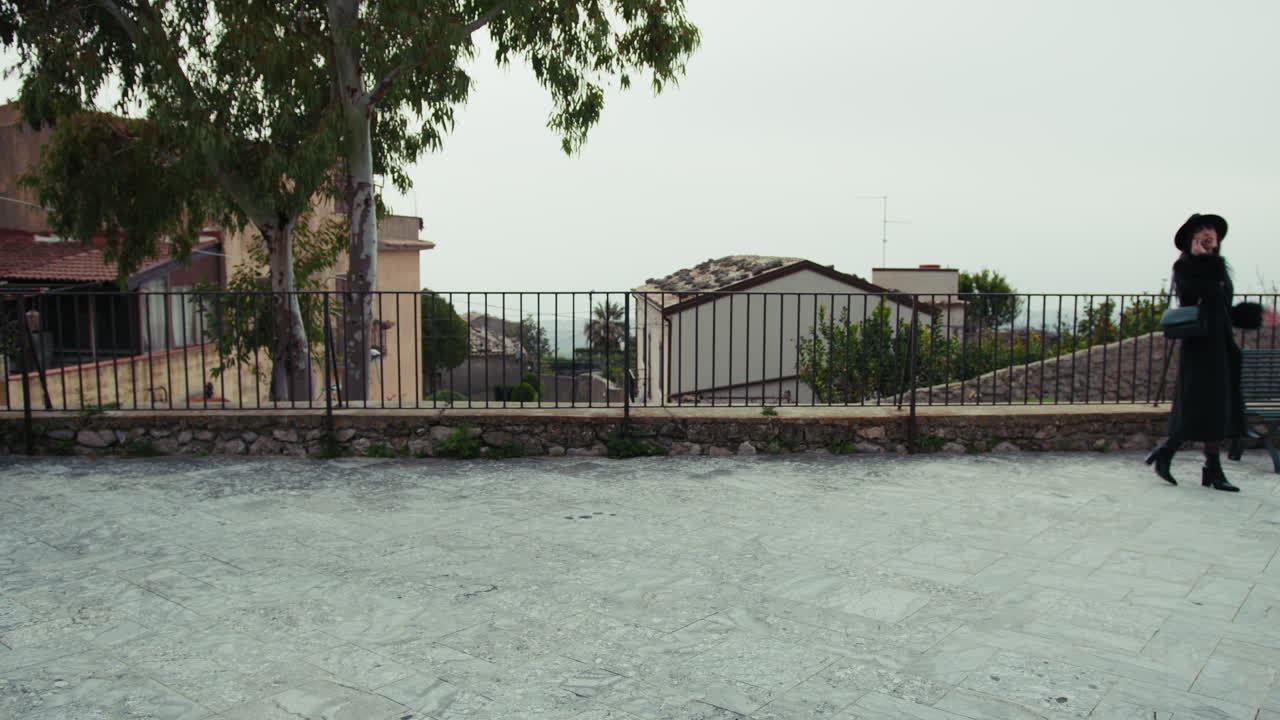 Elegant Woman Walking In The Streets Of A Small Town In Italy