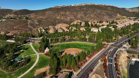 Toma-Aérea-De-Un-Campo-De-Béisbol-Y-Una-Colina-En-El-Fondo-De-Las-Colinas-De-San-Elijo-Sobre-San-Marcos,-California,-Ee.uu.-En-Una-Mañana-Soleada