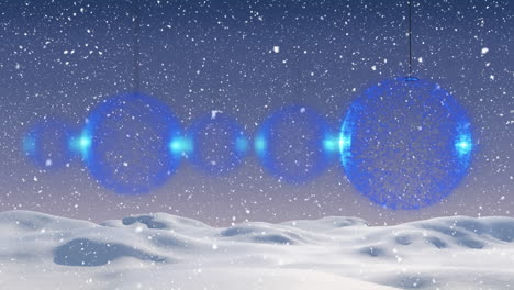 animation of baubles and falling snow over winter landscape