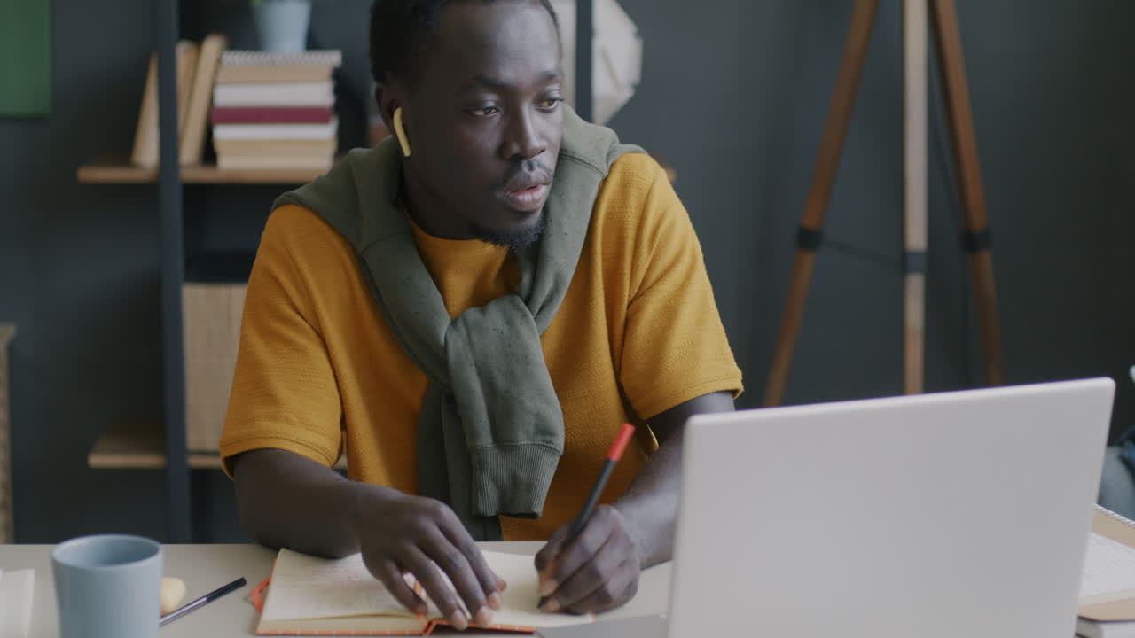Young Man Studying Online at Home