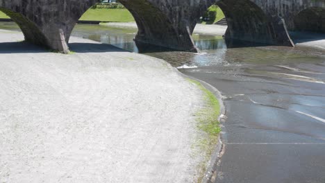 a river flowing under nishida bridge in ishibashi park