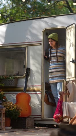 woman exploring a camper van in autumn