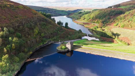 aerial drone video of the beautiful english countryside, wild landscape showing moorlands covered in heather, large lakes and blue water