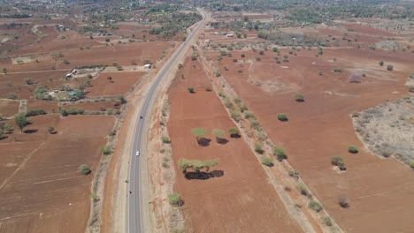 aerial of a long highway running through a beautiful kenyan landscape