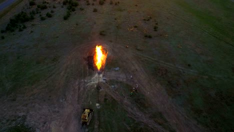 aerial shooting flaring of high-pressure gas from the gas well at sunset.