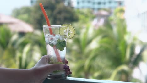 young lady stands on hotel balcony with beautiful view